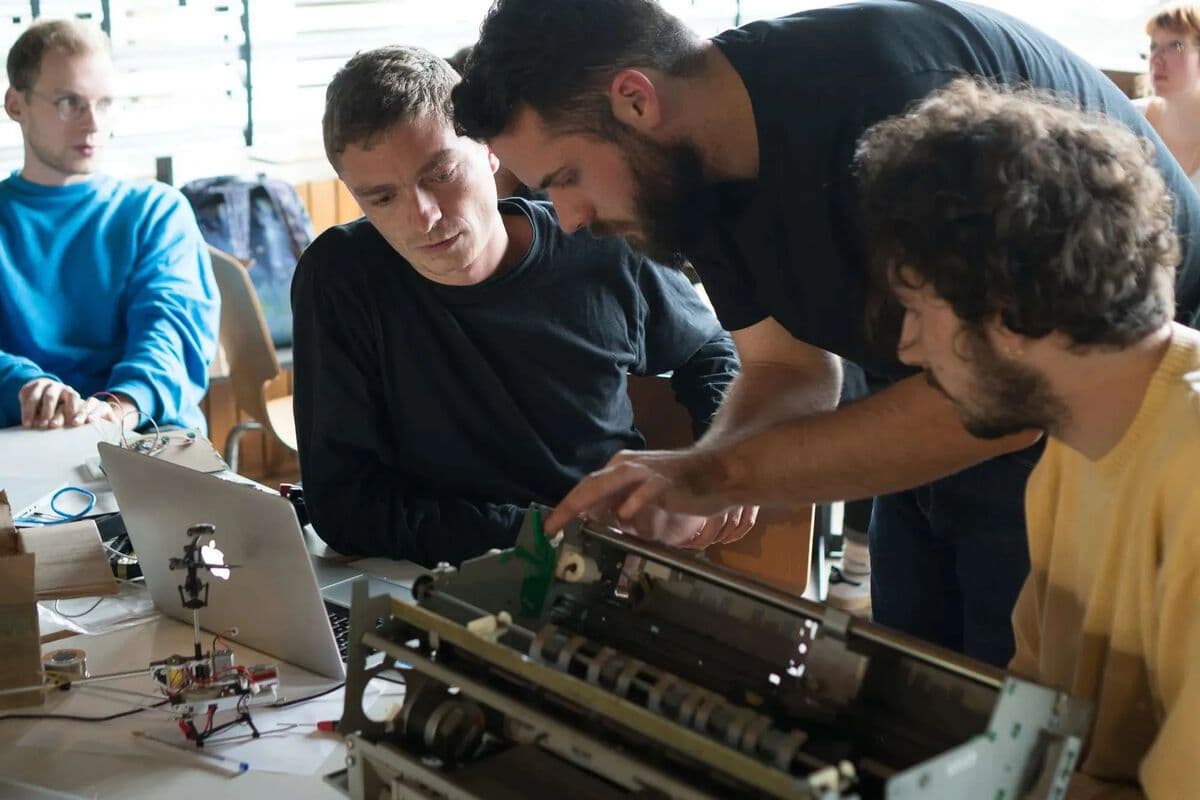 Deconstructed office equipment being repurposed into custom drawing machines